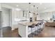 Modern kitchen features an island with barstool seating, stainless appliances, and hardwood floors at 6078 Hardwick Dr, Whitestown, IN 46075