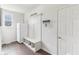 Mud room featuring a built-in hall tree with bench and cubbies, coat hooks, and a white refrigerator at 6078 Hardwick Dr, Whitestown, IN 46075