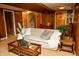 Finished basement with cozy seating area, wood-paneled walls, and warm lighting at 6126 Rucker Rd, Indianapolis, IN 46220