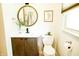 Stylish bathroom with a round mirror, modern vanity, and a clean, well-lit space at 6126 Rucker Rd, Indianapolis, IN 46220