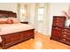 Cozy bedroom with a wooden bed frame, warm lighting, and a comfortable atmosphere at 6126 Rucker Rd, Indianapolis, IN 46220