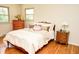 Bright bedroom with a comfortable bed, wooden floors, and natural light from the windows at 6126 Rucker Rd, Indianapolis, IN 46220