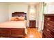 Inviting bedroom featuring hardwood floors, large windows, and coordinating furniture at 6126 Rucker Rd, Indianapolis, IN 46220