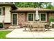 Exterior patio area featuring a dining table with chairs, an umbrella, and brick accents at 6126 Rucker Rd, Indianapolis, IN 46220
