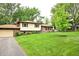 Charming home with well-manicured lawn, inviting curb appeal, and attached garage at 6126 Rucker Rd, Indianapolis, IN 46220