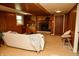 Cozy living room with wood paneled walls, fireplace, and comfortable seating at 6126 Rucker Rd, Indianapolis, IN 46220
