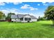 Expansive backyard featuring lush lawn, mature trees, and a charming white brick home with a gray roof at 6190 S 425 W, Pendleton, IN 46064