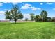 Expansive backyard with lush green grass, mature trees, and shed, perfect for outdoor activities at 6190 S 425 W, Pendleton, IN 46064