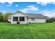 Backyard view of a white brick house with large windows and a well-manicured lawn under a blue sky at 6190 S 425 W, Pendleton, IN 46064