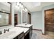 Bathroom featuring a double sink vanity with dark wood cabinets, framed mirrors, and tile floors at 6190 S 425 W, Pendleton, IN 46064
