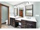 Bright bathroom featuring a double sink vanity with dark wood cabinets and framed mirrors at 6190 S 425 W, Pendleton, IN 46064