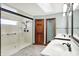 Bathroom showcasing a glass enclosed shower, double sink vanity, and tile floors at 6190 S 425 W, Pendleton, IN 46064