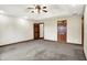 Expansive bedroom with tray ceiling, ceiling fan, and access to other rooms at 6190 S 425 W, Pendleton, IN 46064