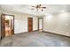 Spacious bedroom with tray ceiling, ceiling fan, and multiple doorways at 6190 S 425 W, Pendleton, IN 46064