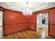 Formal dining room with classic chandelier, hardwood floors, and elegant trim at 6190 S 425 W, Pendleton, IN 46064