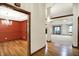 Open view from foyer into dining room featuring hardwood floors, open rooms and stone fireplace at 6190 S 425 W, Pendleton, IN 46064