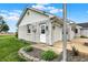 Exterior view of a white brick house with attached garage, landscaped garden bed, and a blue sky at 6190 S 425 W, Pendleton, IN 46064