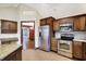 A kitchen with custom wood cabinets, stainless appliances, granite countertops, and a tile backsplash at 6190 S 425 W, Pendleton, IN 46064