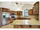 A kitchen with custom wood cabinets, stainless appliances, granite countertops, and a large island at 6190 S 425 W, Pendleton, IN 46064