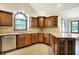 A kitchen with custom wood cabinets, stainless appliances, granite countertops, and a large window overlooking the property at 6190 S 425 W, Pendleton, IN 46064