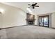 Bright living room features a stone fireplace, skylights, and sliding doors to the outdoor patio at 6190 S 425 W, Pendleton, IN 46064