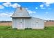 Charming outbuilding with double doors set in a verdant green lawn against a clear sky at 6190 S 425 W, Pendleton, IN 46064