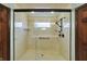 Detail of a tiled shower featuring a glass enclosure, a built-in seat, and dual shower heads at 6190 S 425 W, Pendleton, IN 46064