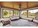 Bright sunroom with multiple windows providing a view of the lush backyard at 6190 S 425 W, Pendleton, IN 46064