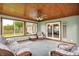 Cozy sunroom with wood ceiling, tile floor, and multiple windows at 6190 S 425 W, Pendleton, IN 46064