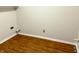 Unfinished basement space with painted walls and wood flooring, ready for customization at 6242 Carrington Dr, Indianapolis, IN 46236