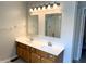 Bathroom with double sink vanity, large mirrors, and bright lighting above at 6242 Carrington Dr, Indianapolis, IN 46236