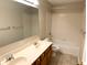Bathroom featuring a double sink vanity, framed mirror, and tub shower combo at 6242 Carrington Dr, Indianapolis, IN 46236