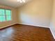 Spacious bedroom with bright window and wood-look floors adding warmth to the space at 6242 Carrington Dr, Indianapolis, IN 46236
