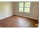 Inviting bedroom filled with natural light from the window and wood-look flooring at 6242 Carrington Dr, Indianapolis, IN 46236