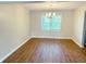Dining room featuring wood floors, neutral paint, window and a chandelier at 6242 Carrington Dr, Indianapolis, IN 46236