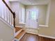Bright foyer featuring wood floors, staircase, and a decorative glass front door at 6242 Carrington Dr, Indianapolis, IN 46236