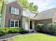 Close-up of home's entry, featuring manicured landscaping and a classic brick facade at 6242 Carrington Dr, Indianapolis, IN 46236