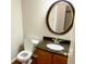 Stylish half bathroom features granite countertop, bronze fixtures and an oval mirror at 6242 Carrington Dr, Indianapolis, IN 46236