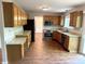 Updated kitchen with light stone countertops, stainless steel appliances, and oak cabinets at 6242 Carrington Dr, Indianapolis, IN 46236