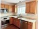 Bright kitchen showcasing stone countertops, stainless steel appliances and warm wood cabinets at 6242 Carrington Dr, Indianapolis, IN 46236