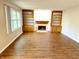 Inviting living room with a fireplace, built-in shelves, and stylish wood flooring at 6242 Carrington Dr, Indianapolis, IN 46236