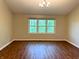 Living room featuring bright windows and wood-look floors adding warmth to the space at 6242 Carrington Dr, Indianapolis, IN 46236