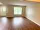 Bright living room featuring sleek wood flooring and a large window providing natural light at 6242 Carrington Dr, Indianapolis, IN 46236