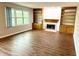 Cozy living room featuring a fireplace, built-in shelves, and large windows for natural light at 6242 Carrington Dr, Indianapolis, IN 46236