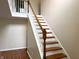 Beautiful staircase with wooden steps, white risers, and an attractive wooden banister at 6242 Carrington Dr, Indianapolis, IN 46236