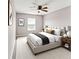 Bright bedroom boasts neutral tones, plush bedding, ceiling fan, and elegant decor with ample light at 6463 Wasco Dr, Whitestown, IN 46075
