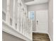 Bright entryway with white railings, wood floors, a front door, and a window at 6463 Wasco Dr, Whitestown, IN 46075