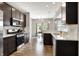 Modern kitchen featuring stainless steel appliances, granite countertops, and dark wood cabinets at 6463 Wasco Dr, Whitestown, IN 46075