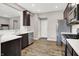 Modern kitchen boasts stainless steel appliances, stone countertops and dark wood cabinets at 6463 Wasco Dr, Whitestown, IN 46075