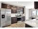 Contemporary kitchen with stainless steel appliances, granite counters, and dark wood cabinets at 6463 Wasco Dr, Whitestown, IN 46075
